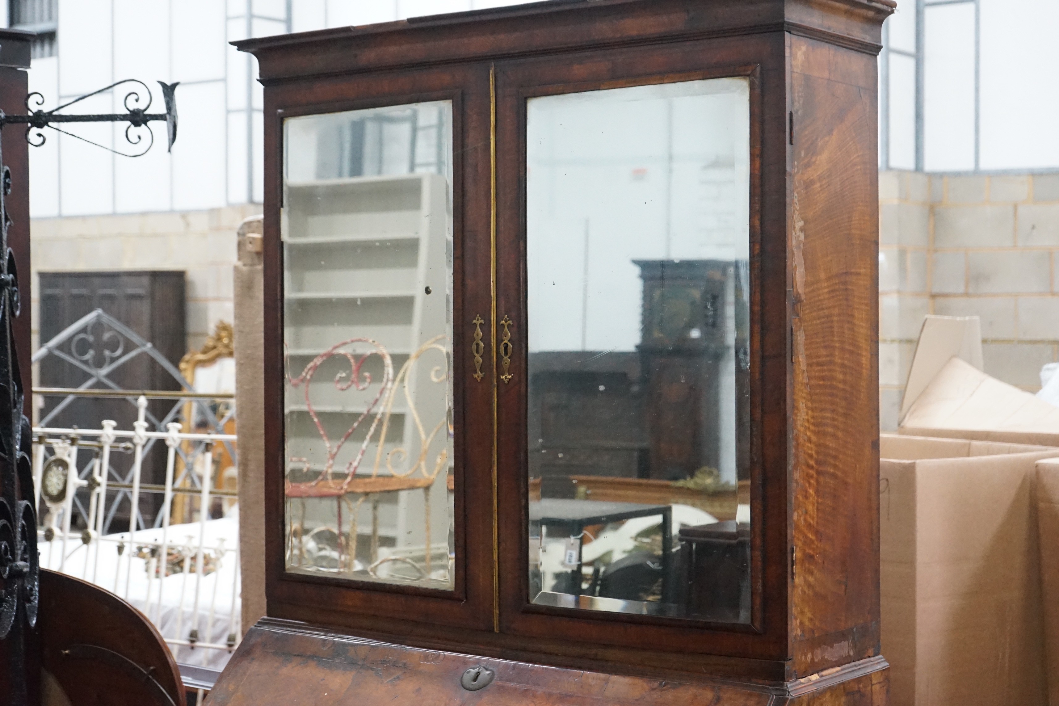 A mid 18th century feather banded figured walnut bureau cabinet, width 111cm, depth 57cm, height 207cm